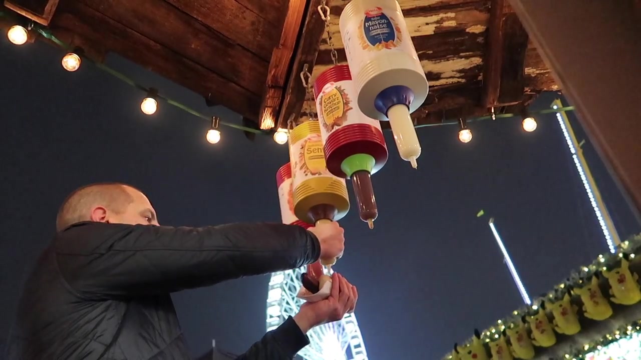 Hanging ketchup and mustard dispensers at the bratwurst stall