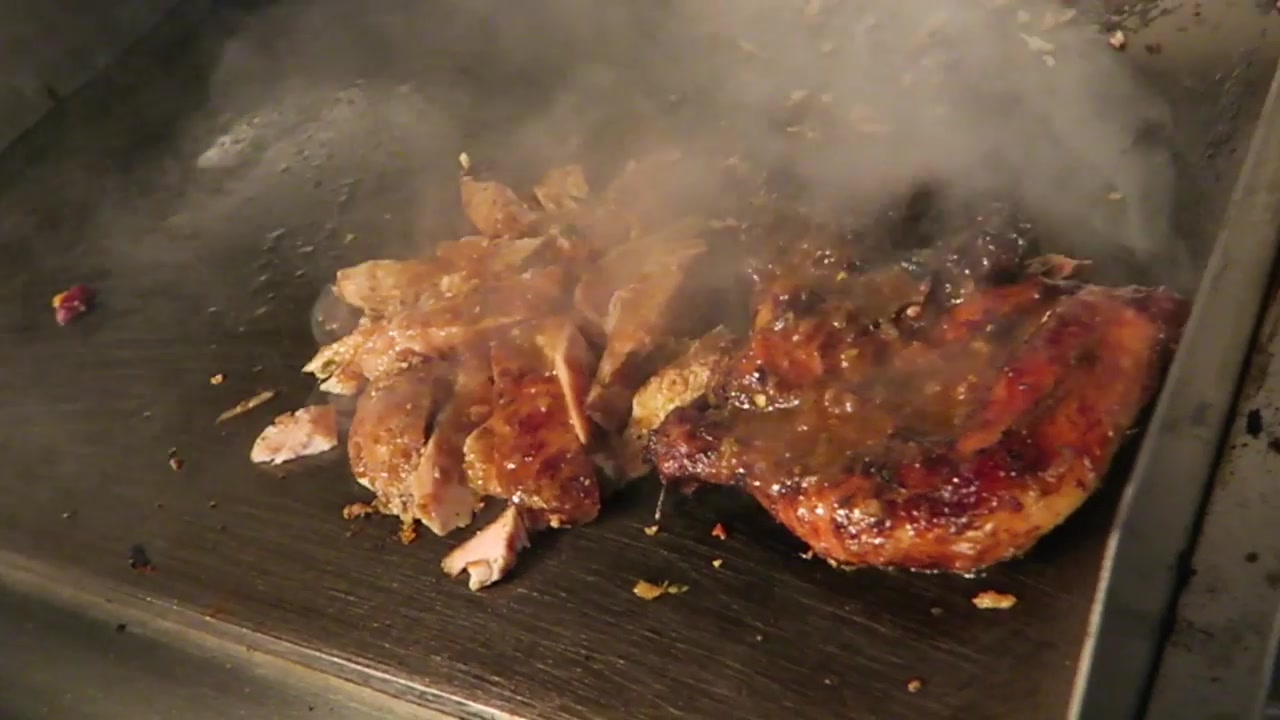 Jerk chicken cooking on the griddle at Mama’s Jerk, Pop Brixton