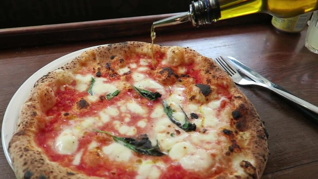 Chilli oil poured over a Margherita pizza at Pizza Pilgrims Soho