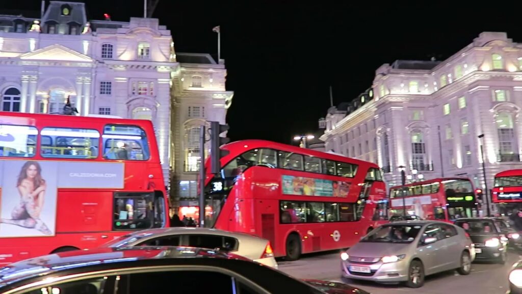 Red buses and illuminated buildings at Piccadilly Circus at night