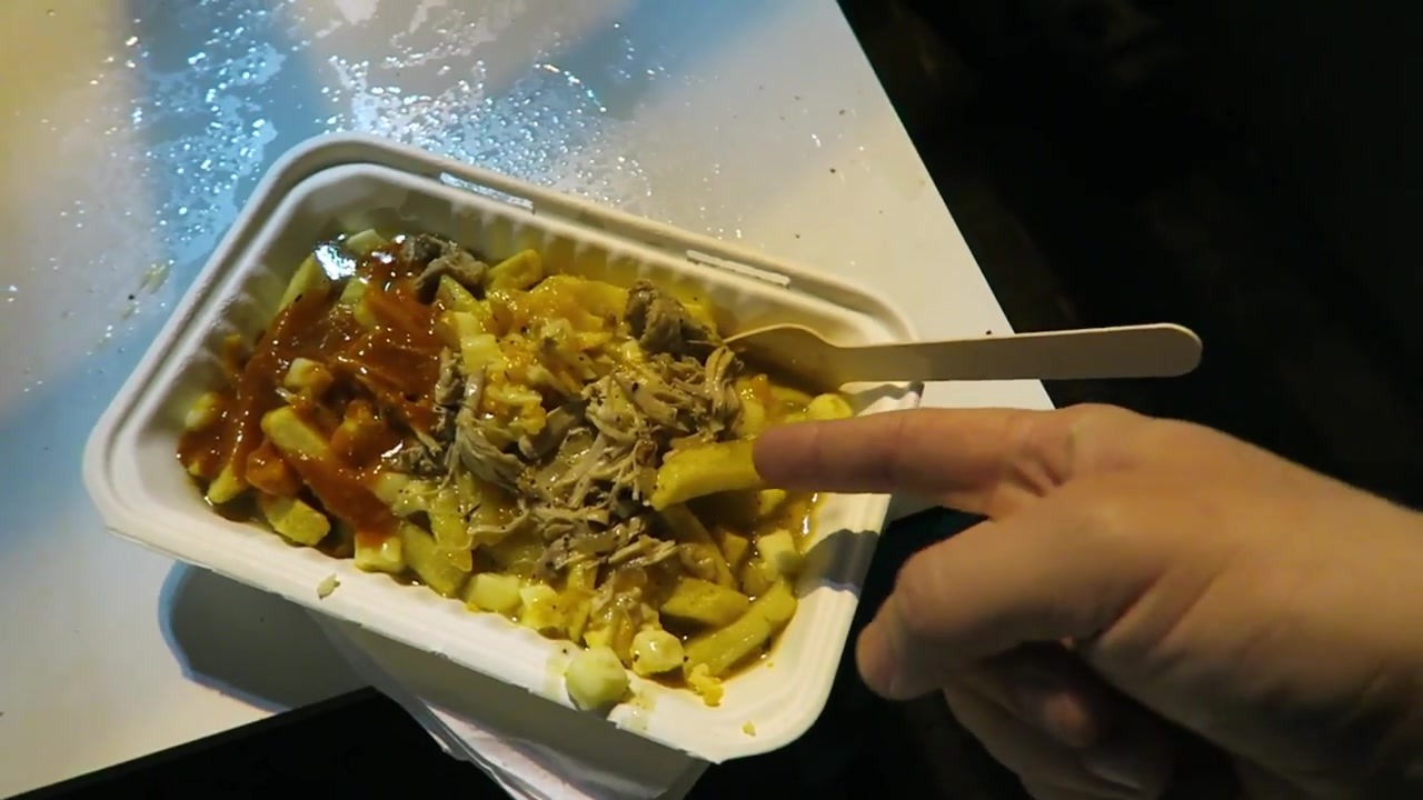Spit & Roast poutine topped with cheese, chicken gravy and hot sauce in 2015
