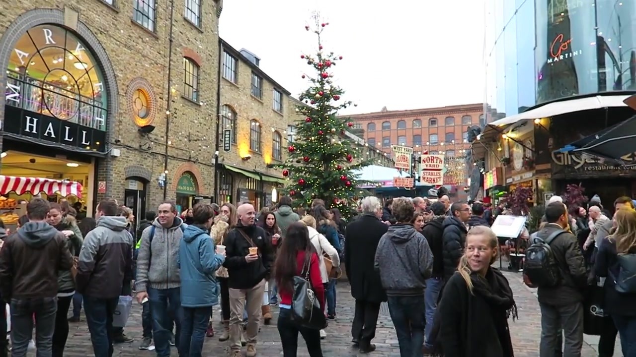 Shoppers and a Christmas tree outside the brick Market Hall at Camden Lock.