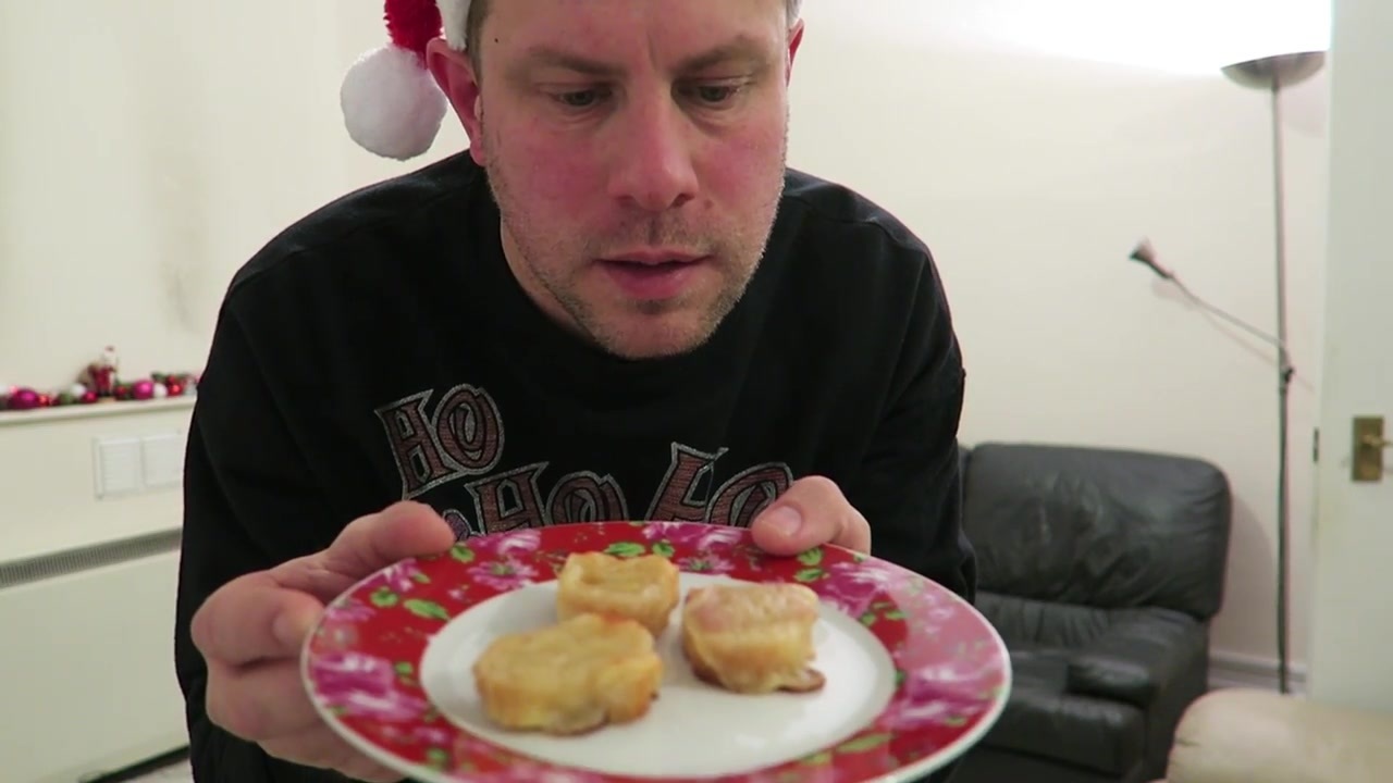 Barry presents miniature cheese-on-toast canapés on a red plate.
