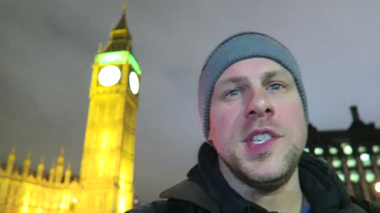 Barry Roberts on Westminster Bridge with Big Ben illuminated behind him.