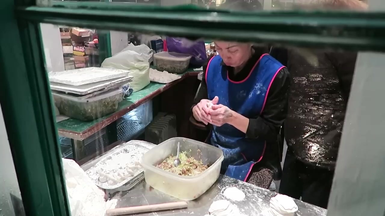 Dumplings being made by hand in the window of Jen Cafe