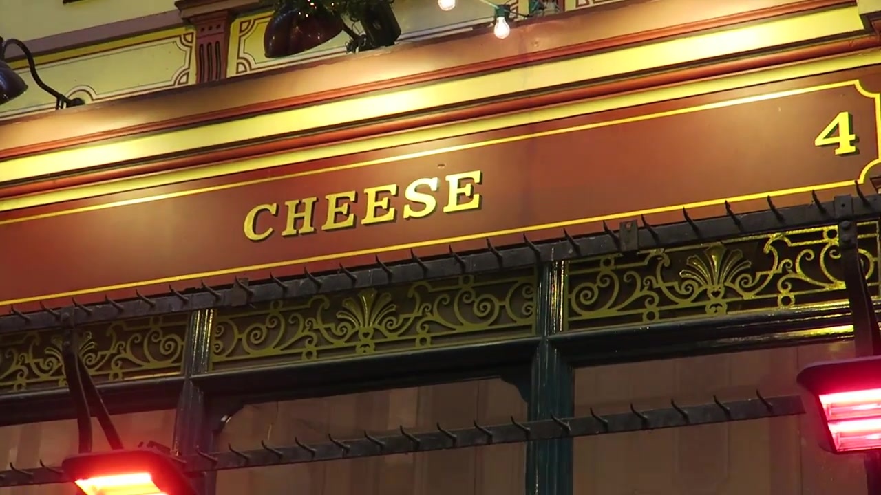 Cheese sign and ornate ironwork above a Leadenhall shopfront
