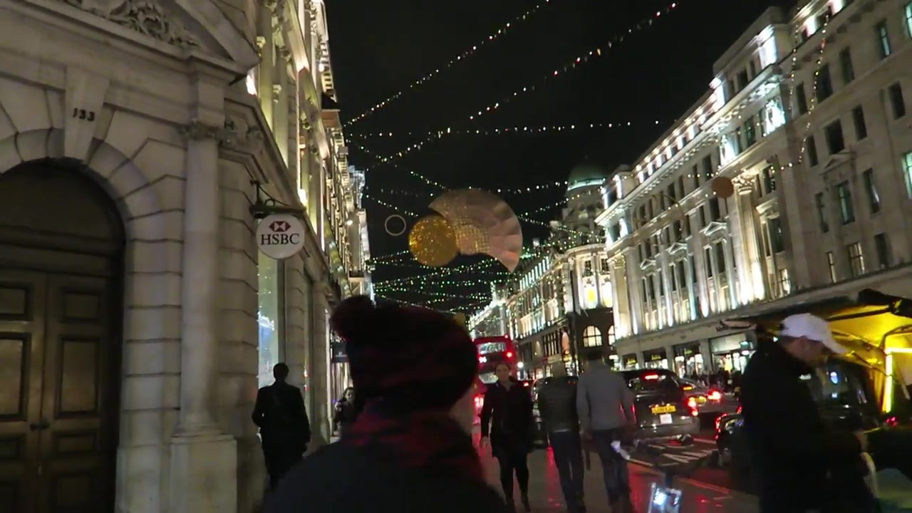 Christmas shoppers beneath lights on Regent Street