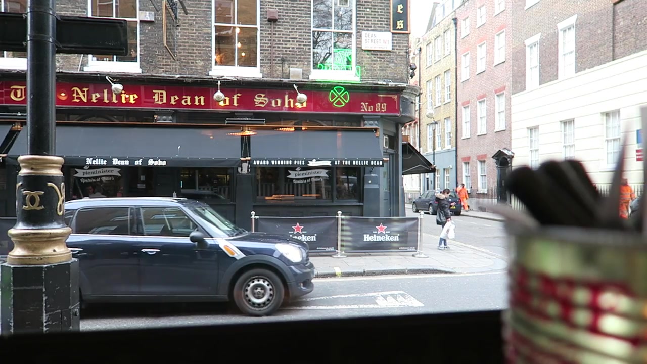 View of the Nellie Dean pub and a passing car from the Pizza Pilgrims window seat