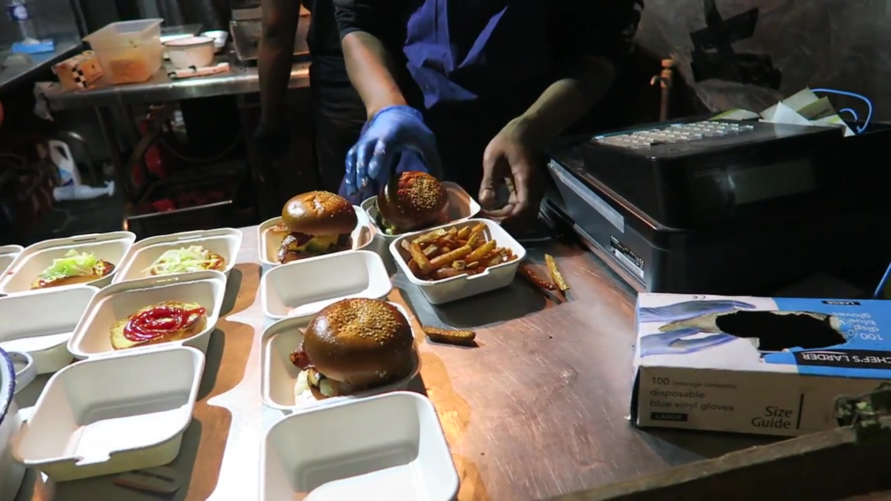 Burgers and fries at the street food counter