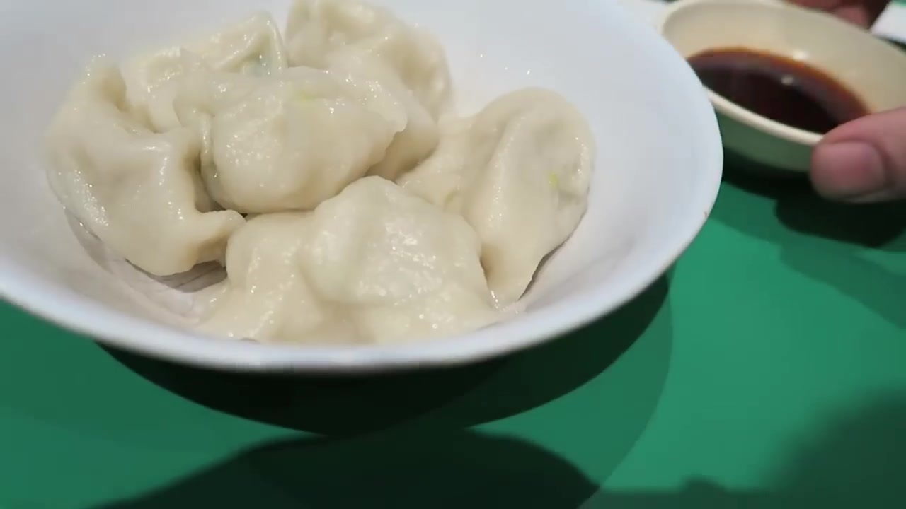 Plate of Beijing pork dumplings with dipping sauce at Jen Cafe