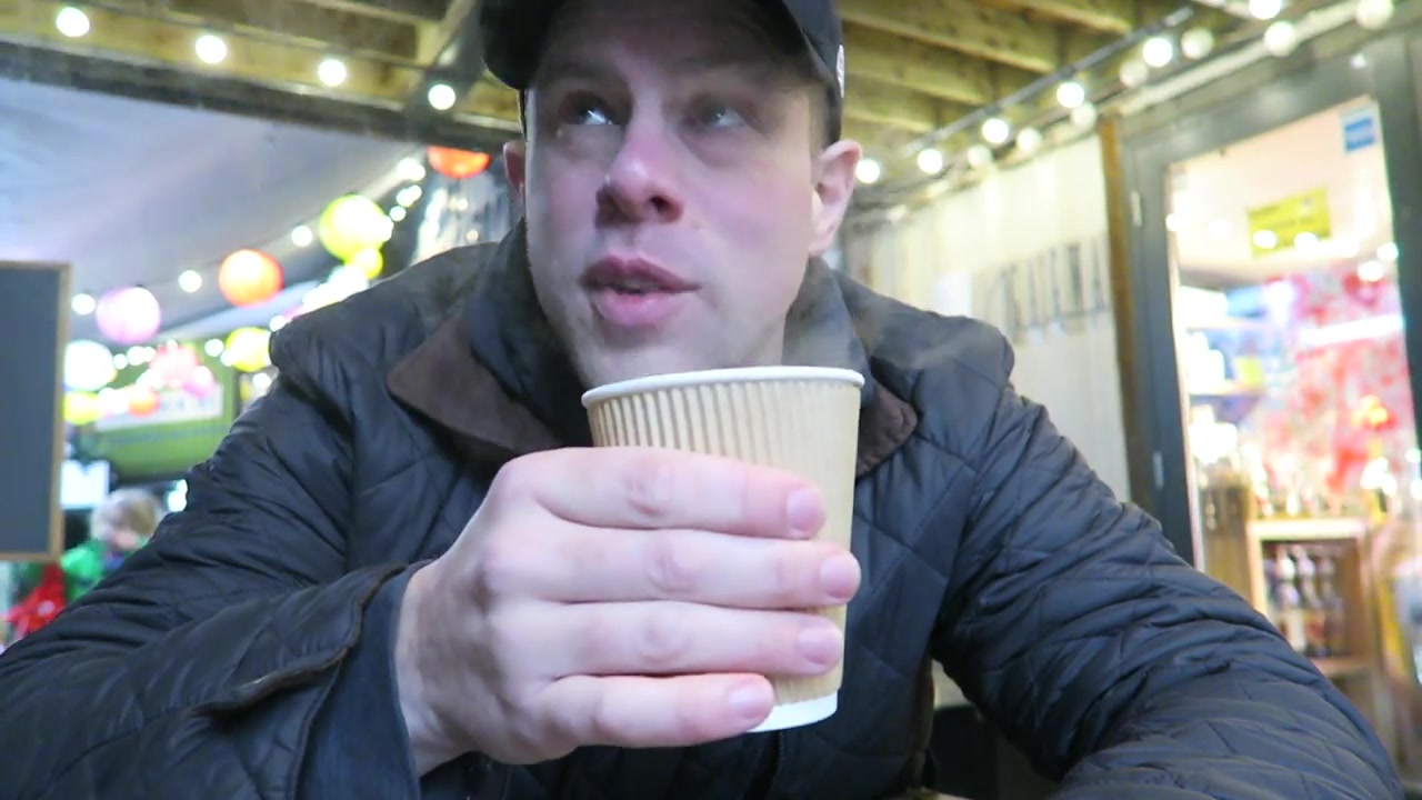 Barry Roberts holding a takeaway coffee at Pop Brixton