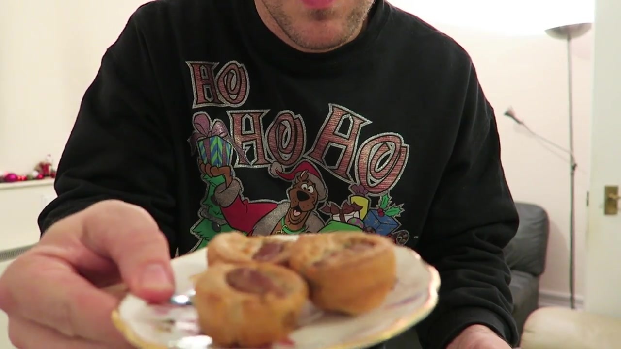 Mini toad-in-the-hole canapés and a Yorkshire pudding held towards the camera.