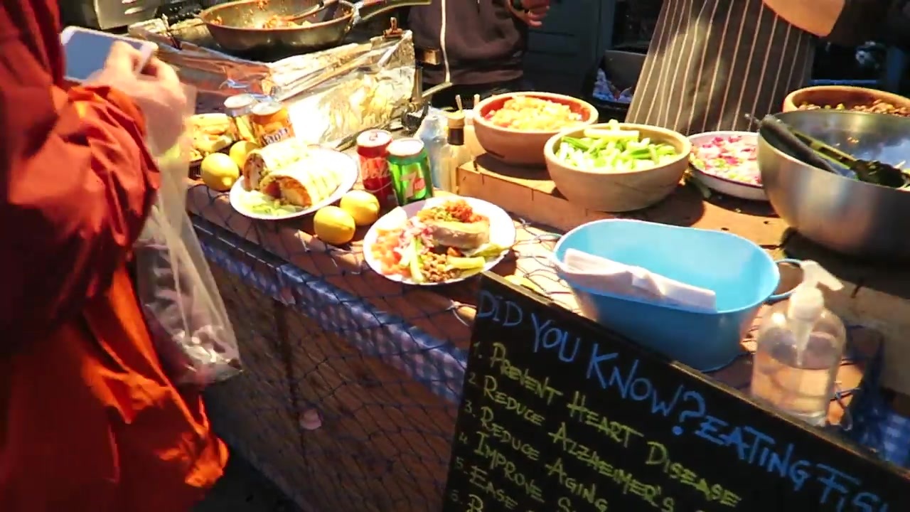 A Camden market food counter with bowls of prepared ingredients and dishes.
