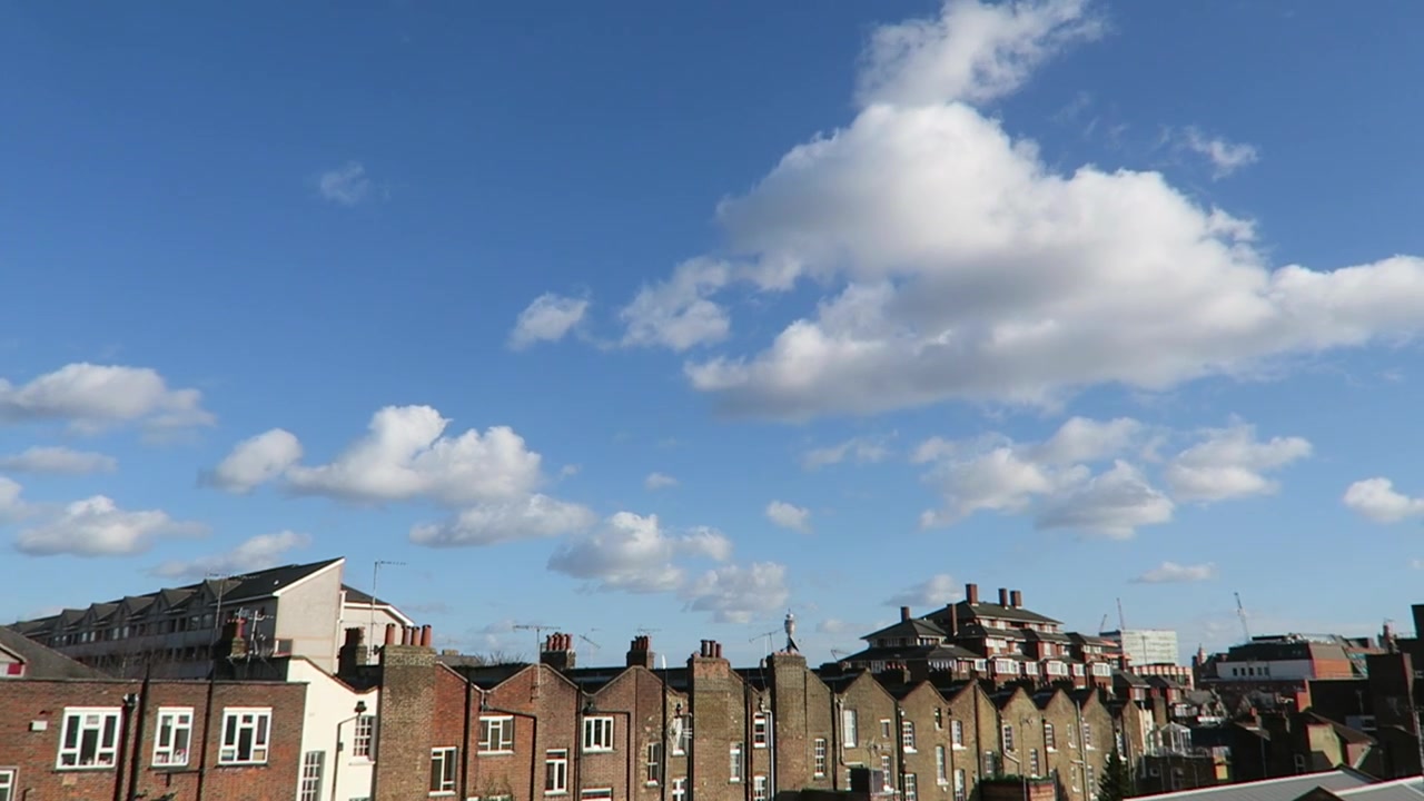 London brick rooftops beneath blue sky viewed from Alfies terrace