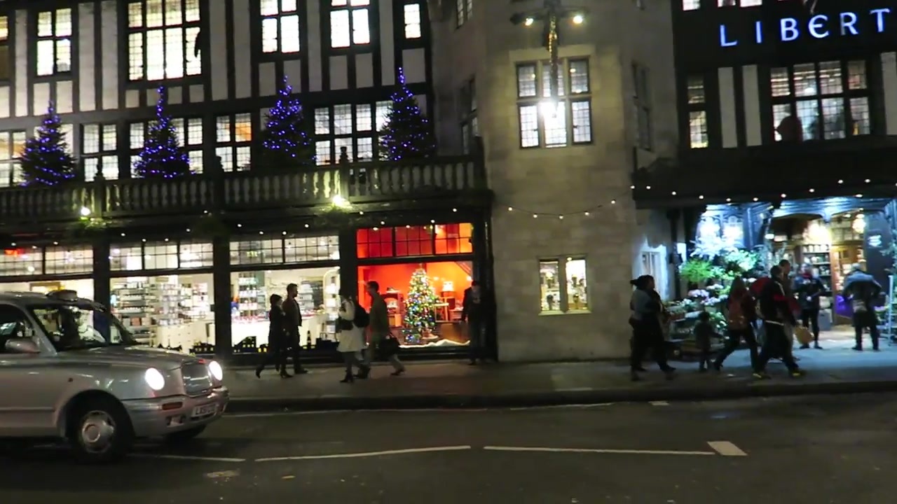Liberty’s illuminated sign and timber-framed frontage at night