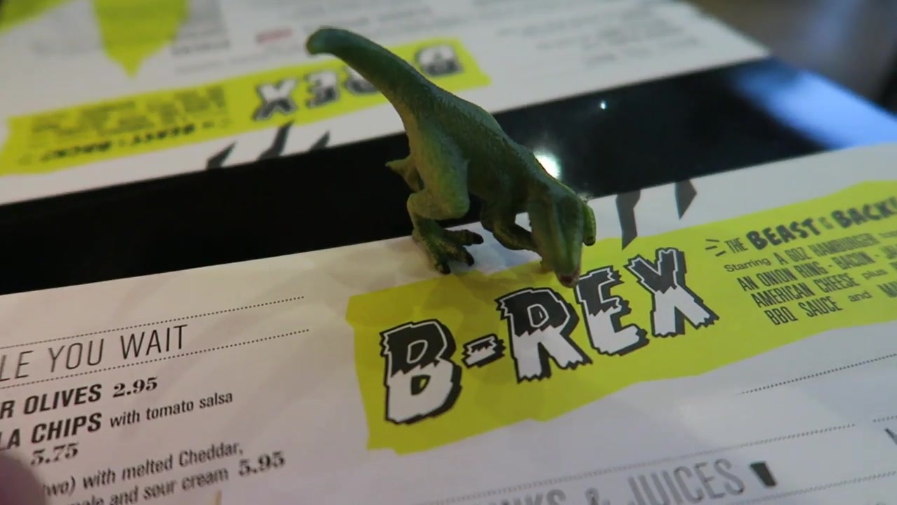 The B-Rex menu and toy dinosaur from the restaurant invitation.