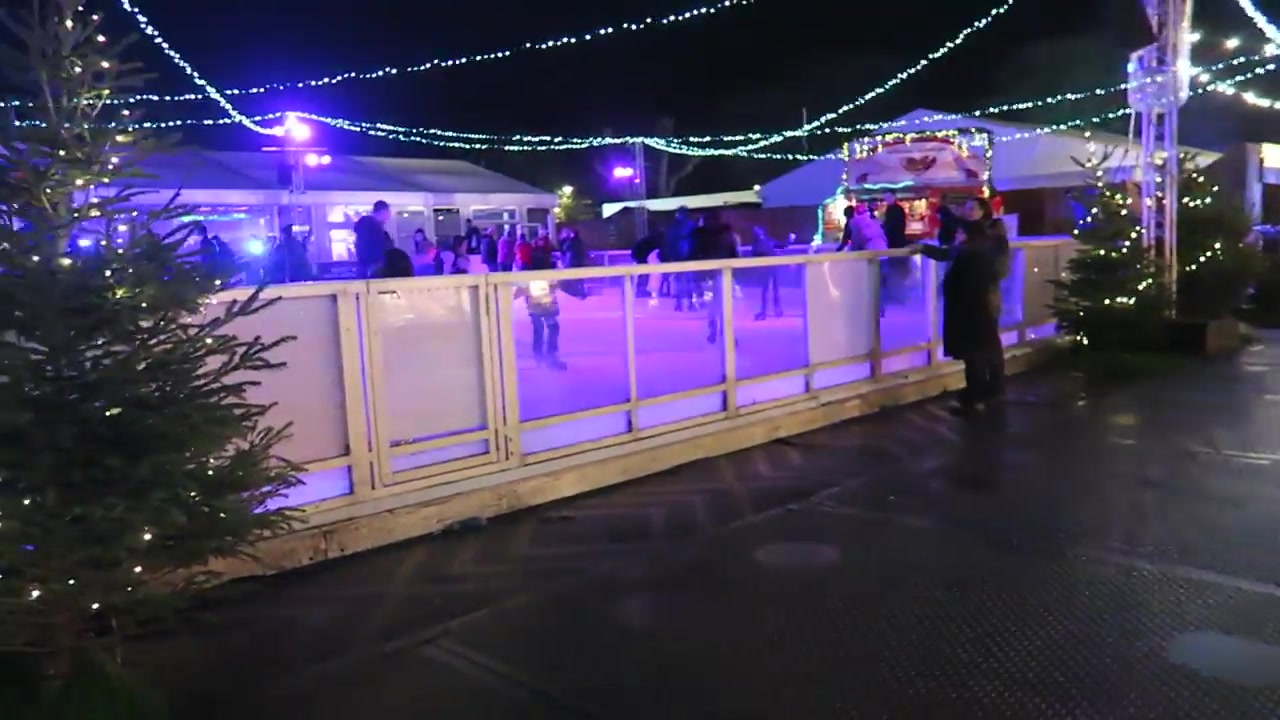 Winterville ice rink and Ferris wheel at night