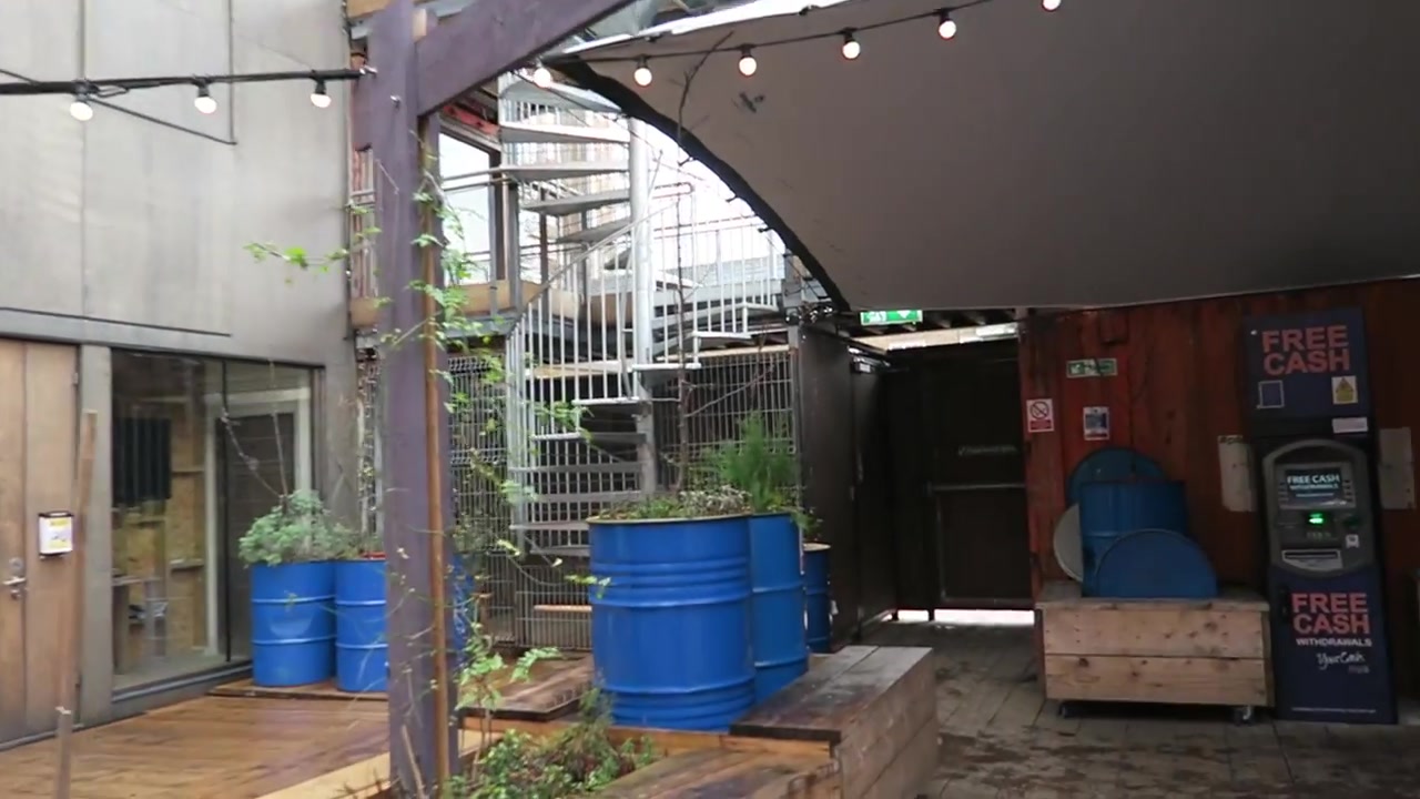 Reused shipping containers and blue barrel planters at Pop Brixton