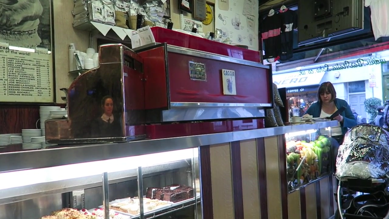 Red espresso machine and cake display inside Bar Italia Soho
