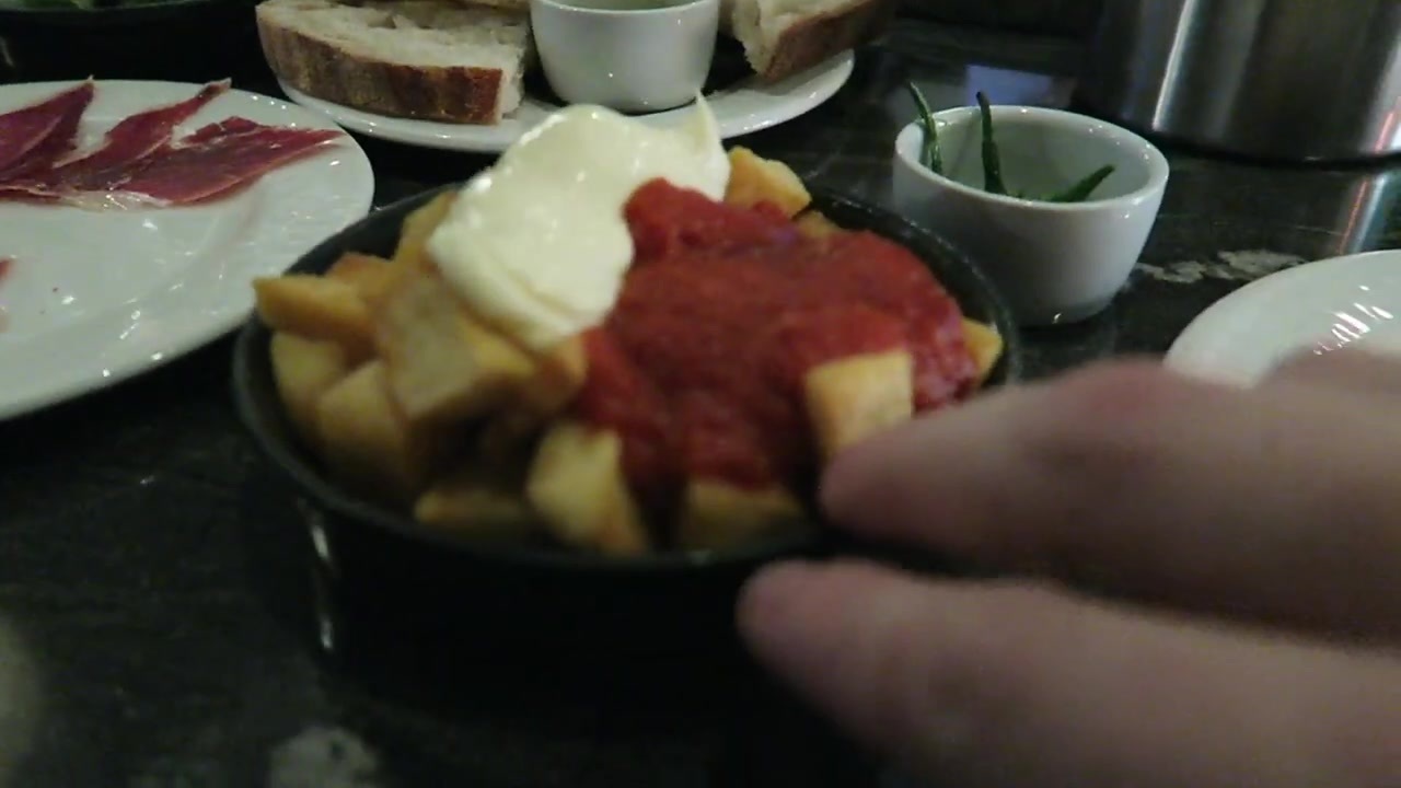 Patatas bravas topped with red tomato sauce and white mayonnaise at José Pizarro.