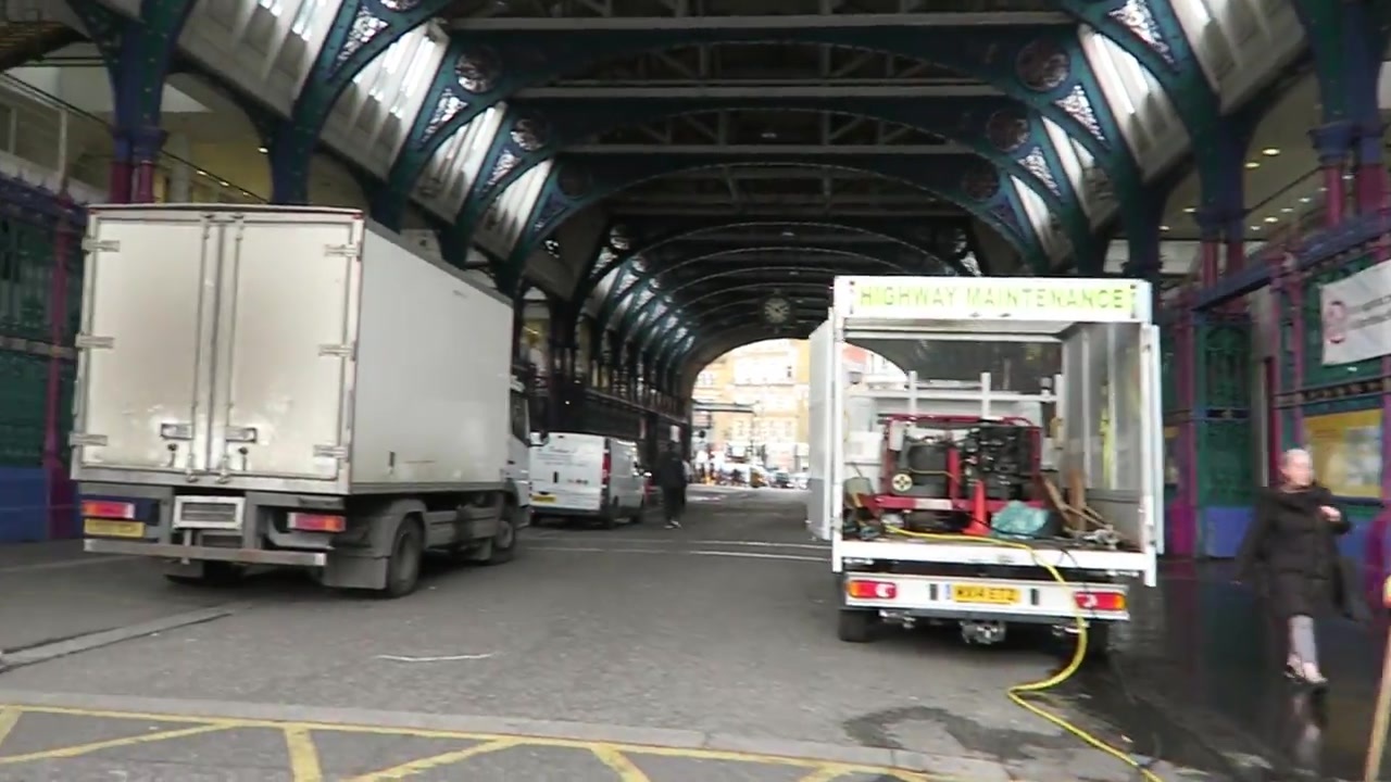 Vans beneath the covered passage at Smithfield Market