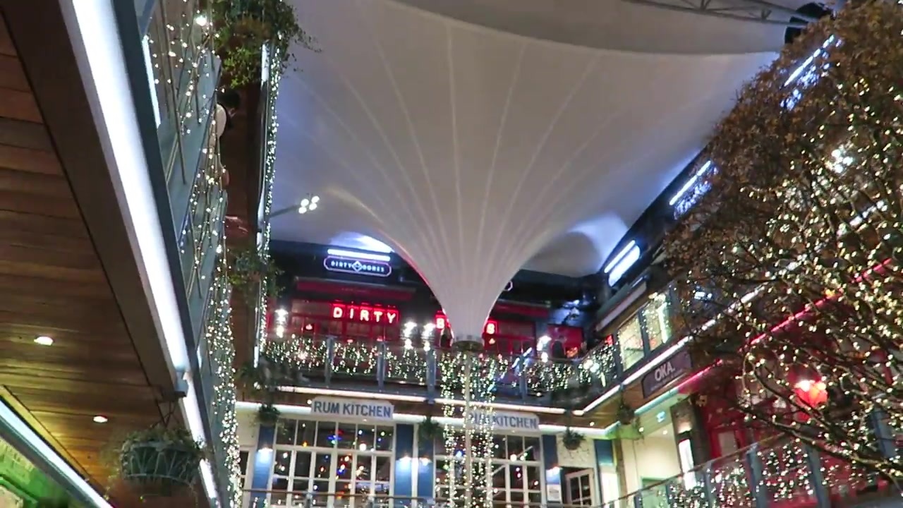 Covered courtyard with strings of Christmas lights and upper-level balconies
