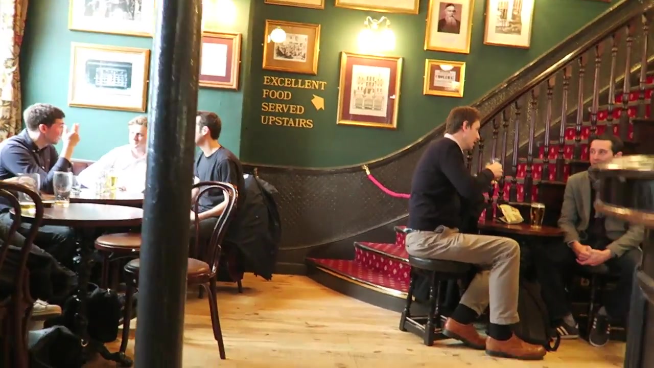 Interior of the John Snow pub with framed pictures and staircase