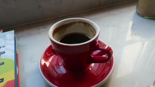 Black coffee in a red cup at London Grind.
