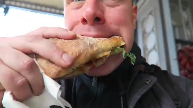 Barry eating a chorizo roll from Brindisa at Borough Market.