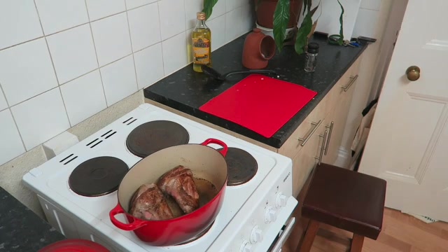Lamb shanks browning in a red casserole in Barry’s kitchen.