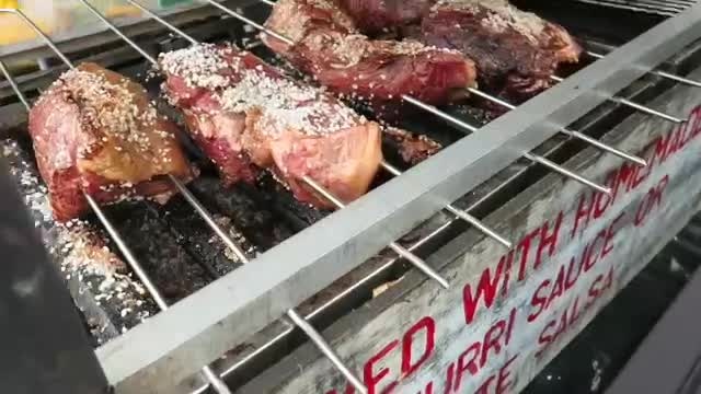 Meat cooking on a barbecue grill at Camden Market in 2016