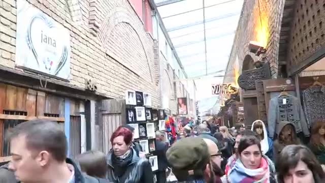A busy covered passage of shops and stalls at Camden Market in 2016