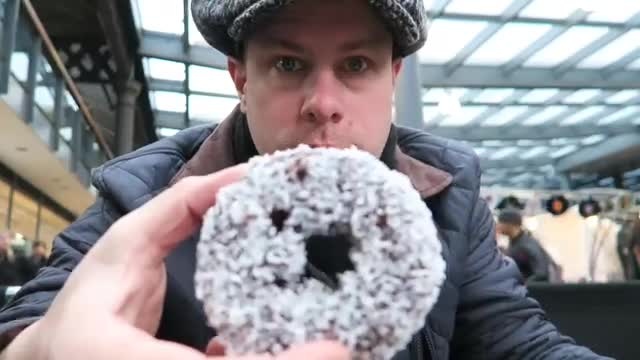 Barry holding Crosstown’s coconut-covered Lam-nut doughnut at Spitalfields in 2016