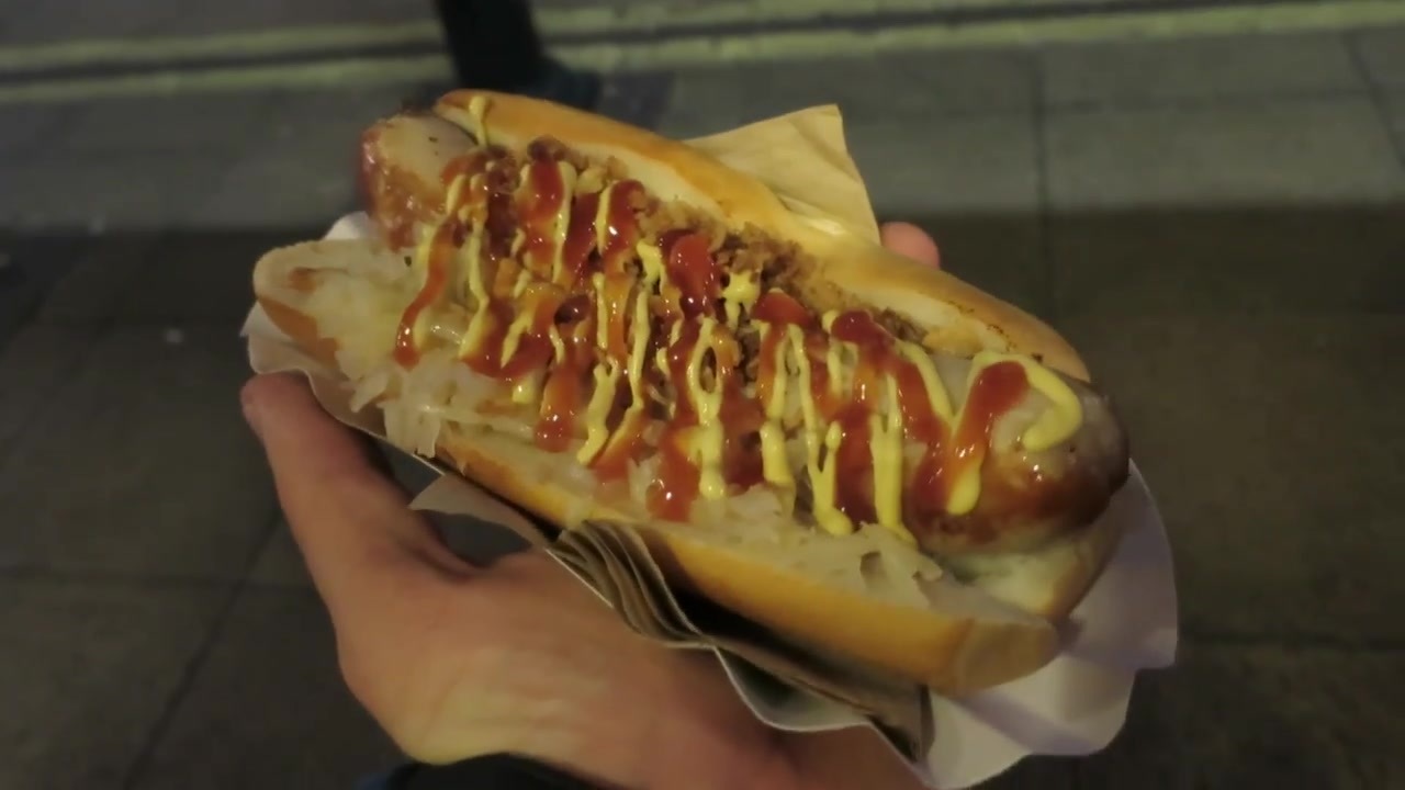 Bratwurst in a roll with onions, sauerkraut, ketchup and mustard in December 2014.