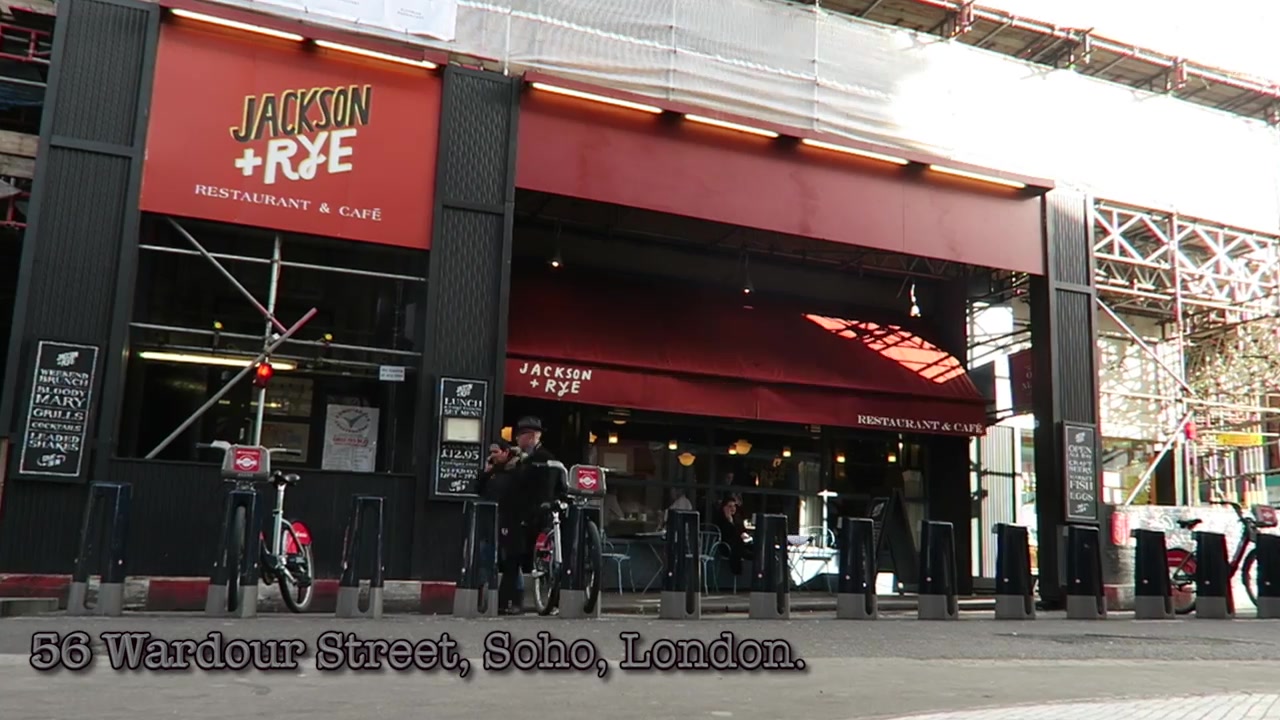 The red awning and corner entrance of Jackson & Rye on Wardour Street, Soho, in 2016.