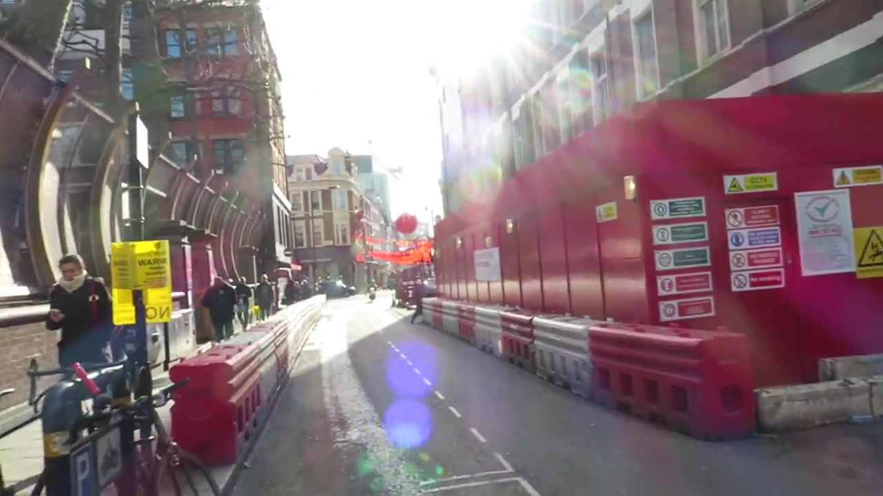 Sunlit Chinatown street with red lanterns and decorations for Chinese New Year in February 2016.