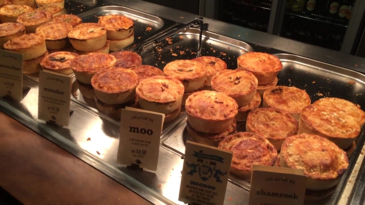 Golden pies displayed on trays at Pieminister