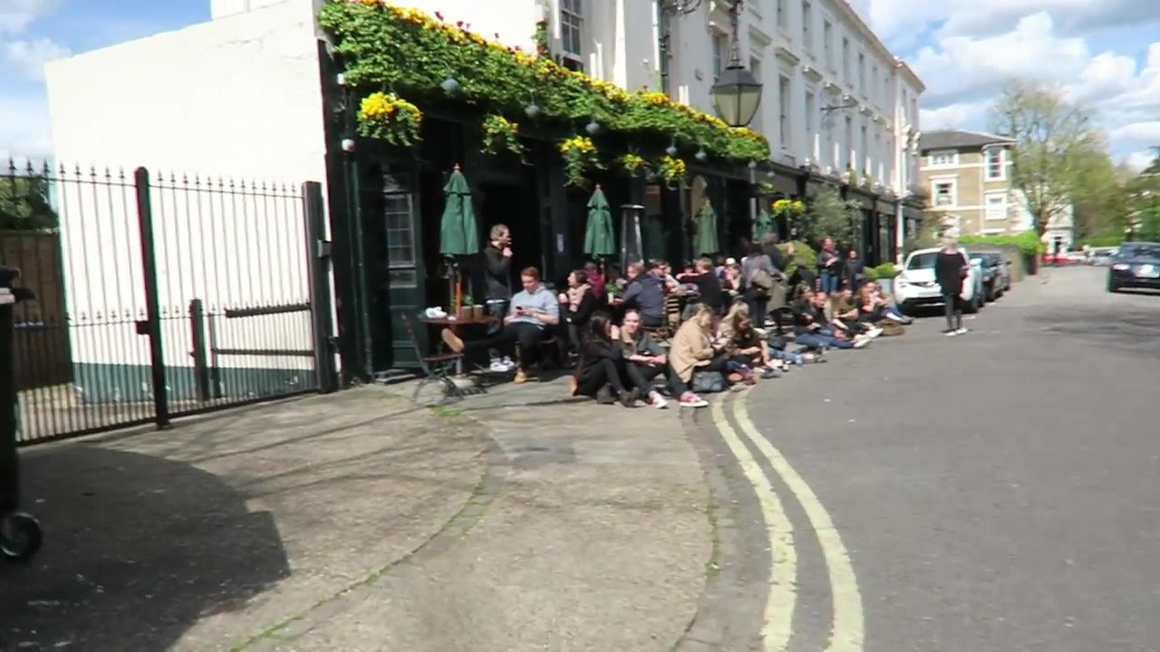 People outside the Warwick Castle pub on a sunny afternoon