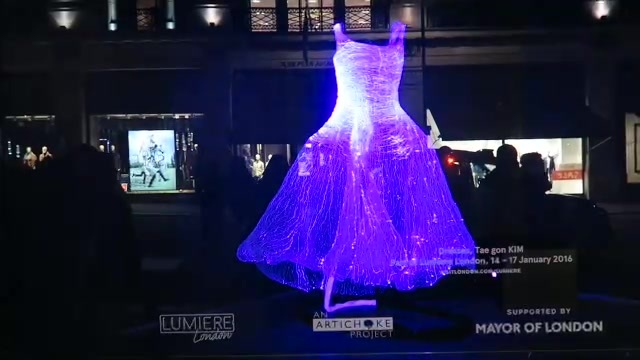 Purple illuminated dress displayed in a Liberty window at Lumiere London 2016