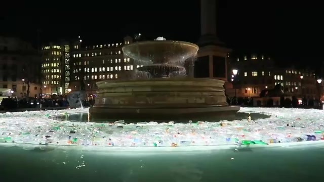 Illuminated bottles around a Trafalgar Square fountain at Lumiere London 2016