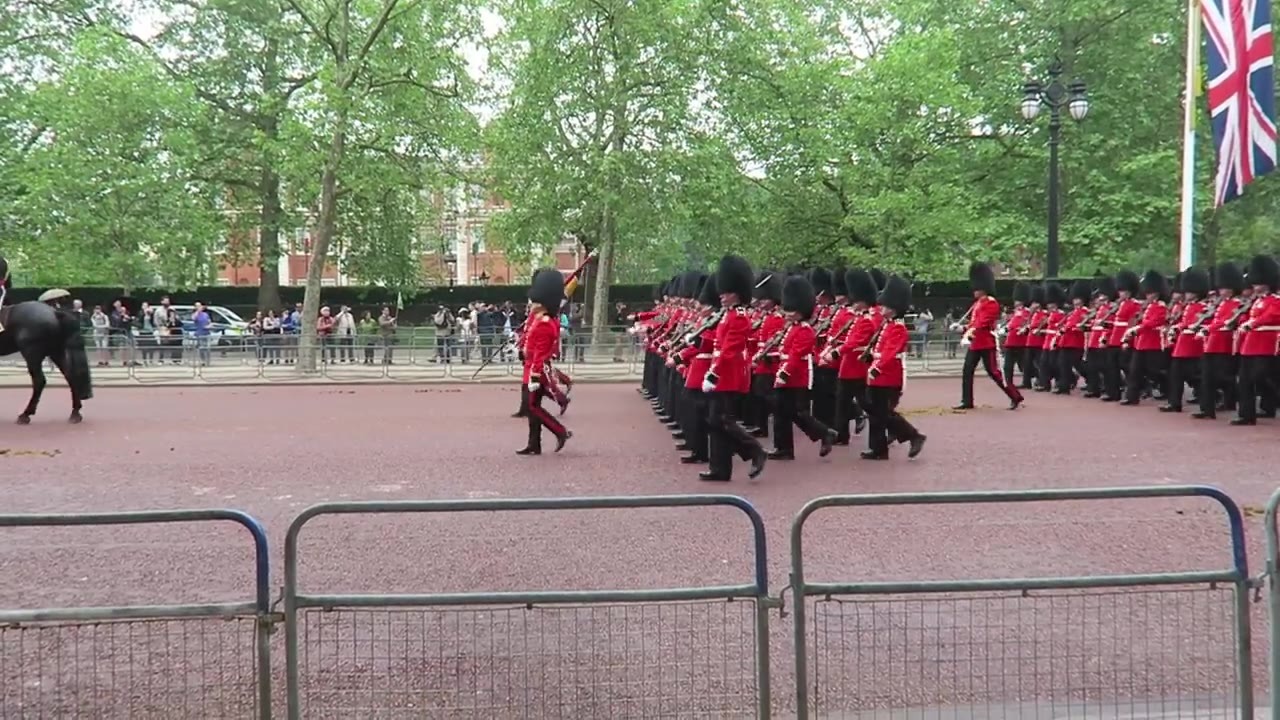 Foot Guards in scarlet tunics marching along The Mall