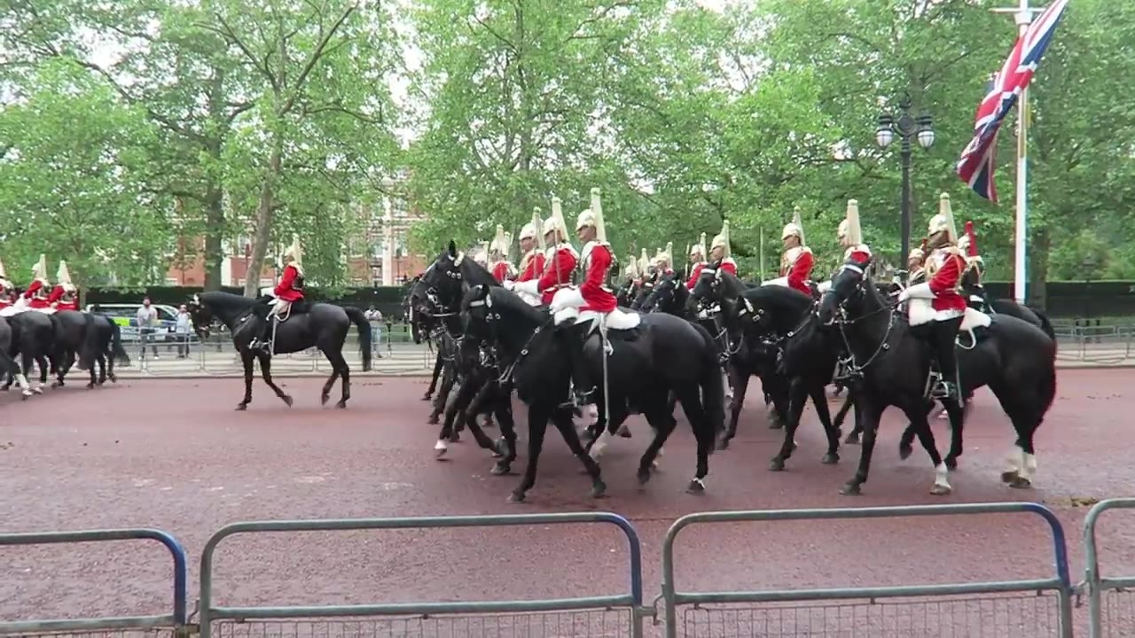 Mounted musicians in ceremonial uniform passing along The Mall