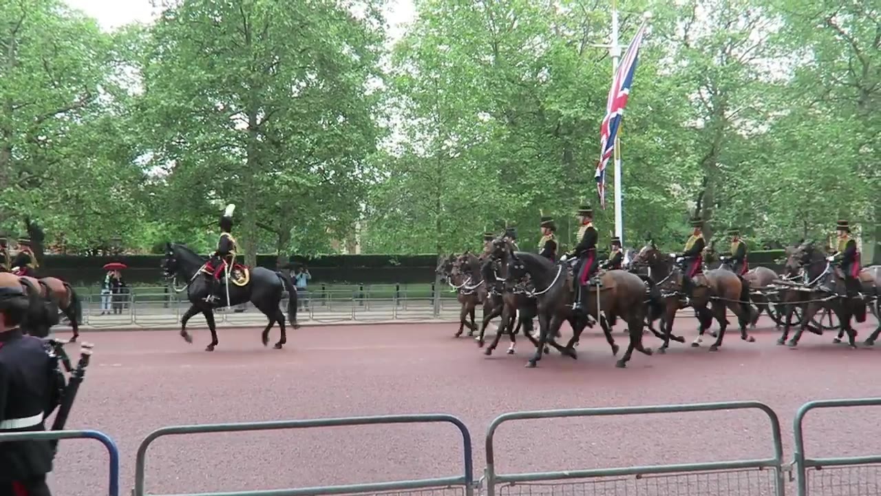 Mounted troops passing along The Mall beneath Union flags