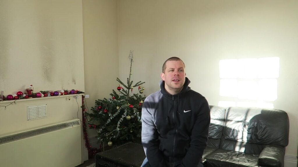 Robert wishing viewers a happy New Year beside the Christmas tree in 2016.
