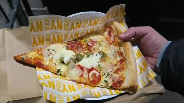 Fabio pizza slice with salami, olives, tomatoes and mozzarella at NY Fold in 2016